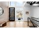 Bright entryway with hardwood floors, modern door and staircase at 3485 S Clermont St, Denver, CO 80222