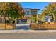 Modern two-story home with wood fence and attached garage at 3485 S Clermont St, Denver, CO 80222