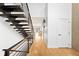 Light hardwood hallway with modern staircase and open feel at 3485 S Clermont St, Denver, CO 80222