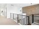 Bright upper hallway with modern metal railing and carpet flooring at 3485 S Clermont St, Denver, CO 80222