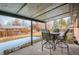 Back patio beneath a covered porch featuring a four-chair dining set at 12235 E Kentucky Ave, Aurora, CO 80012