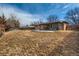 Back of house showcasing covered patio, fenced yard, and blue skies at 12235 E Kentucky Ave, Aurora, CO 80012