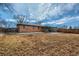 Back of house featuring covered patio, spacious yard, and wooden fence at 12235 E Kentucky Ave, Aurora, CO 80012