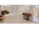 Finished basement space with an antique sewing machine and access to the basement bathroom at 12235 E Kentucky Ave, Aurora, CO 80012