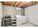 Bright basement laundry room with washer, dryer, and craftsman tool chest at 12235 E Kentucky Ave, Aurora, CO 80012