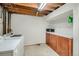 Basement laundry room with washer, dryer, storage shelf and wood cabinets at 12235 E Kentucky Ave, Aurora, CO 80012