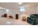 Finished basement features carpet, a plush armchair, and recessed lighting for a comfortable space at 12235 E Kentucky Ave, Aurora, CO 80012