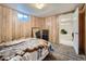 Basement bedroom features a fur-lined bed, wood paneling, and a carpeted floor at 12235 E Kentucky Ave, Aurora, CO 80012