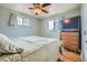 Bedroom featuring light blue walls, a ceiling fan, and a comfy bed with light from the windows at 12235 E Kentucky Ave, Aurora, CO 80012
