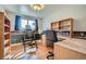 Bedroom featuring hardwood floors, a workstation desk, and an inversion table at 12235 E Kentucky Ave, Aurora, CO 80012