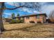Single story brick home with mature tree and manicured lawn at 12235 E Kentucky Ave, Aurora, CO 80012