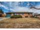 Charming single-story brick home with well-maintained landscaping and an attached garage at 12235 E Kentucky Ave, Aurora, CO 80012