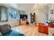 Cozy living room featuring a large window and hardwood floors at 12235 E Kentucky Ave, Aurora, CO 80012