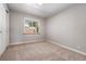 Cozy carpeted bedroom with large window and double closets at 3100 Gray St, Denver, CO 80214