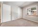 Bright bedroom with carpet, double closet, and window at 3100 Gray St, Denver, CO 80214