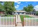 Updated gray house with walkway, white picket fence, and lawn at 3100 Gray St, Denver, CO 80214