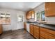 Kitchen with wood cabinets, white appliances, and backyard access at 3100 Gray St, Denver, CO 80214