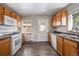 Bright kitchen features wood cabinets, white appliances, and a window at 3100 Gray St, Denver, CO 80214