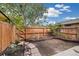 Cozy backyard features a wood fence and garden area with a stone walkway at 1231 S Crystal Way, Aurora, CO 80012