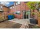 Small backyard patio with a concrete slab, bordered by a wood fence and red siding at 1231 S Crystal Way, Aurora, CO 80012