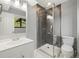Bathroom with modern shower stall and vanity, featuring gray wall tiles and clean white cabinets at 1231 S Crystal Way, Aurora, CO 80012