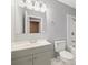 Cozy bathroom features a single vanity, toilet, tub, and shower with clean, neutral colors at 1231 S Crystal Way, Aurora, CO 80012