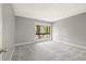Neutral bedroom featuring a large window, carpet, and base-molding at 1231 S Crystal Way, Aurora, CO 80012