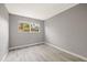 A simple, empty bedroom with a large window at 1231 S Crystal Way, Aurora, CO 80012
