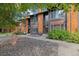 Townhouse exterior features wood siding, stone landscaping, and mature trees at 1231 S Crystal Way, Aurora, CO 80012