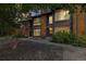 Townhouse exterior features wood siding, stone landscaping, and mature trees at 1231 S Crystal Way, Aurora, CO 80012