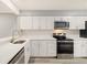Bright kitchen featuring white cabinets, quartz countertops, subway tile backsplash and stainless steel appliances at 1231 S Crystal Way, Aurora, CO 80012