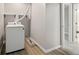 Efficient laundry area features a modern washer, shelving, and clean, neutral decor at 1231 S Crystal Way, Aurora, CO 80012