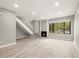 Bright living room boasts wood floors, a fireplace, and a large window at 1231 S Crystal Way, Aurora, CO 80012