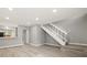Living room showcasing wood floors, stairs, and a kitchen view at 1231 S Crystal Way, Aurora, CO 80012