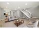 Living room featuring wood floors, stairs, and a kitchen view at 1231 S Crystal Way, Aurora, CO 80012