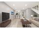 Open living room with wood floors, kitchen view and modern furnishings at 1231 S Crystal Way, Aurora, CO 80012