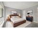 Staged main bedroom features a large bed, stylish furniture, and neutral decor at 1231 S Crystal Way, Aurora, CO 80012