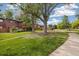 Scenic neighborhood view featuring grassy areas, trees, and sidewalks around the property at 1231 S Crystal Way, Aurora, CO 80012