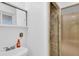 Bright bathroom with a large mirror and shower at 2978 Robb Cir, Lakewood, CO 80215