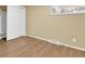 Bright bedroom featuring hardwood floors and a closet with sliding doors at 2978 Robb Cir, Lakewood, CO 80215