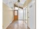 Bright foyer with a tiled floor, a decorative door, and unique stained glass pendant lighting at 2978 Robb Cir, Lakewood, CO 80215