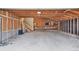 Spacious garage with exposed beam ceiling and a staircase to an upper level at 2978 Robb Cir, Lakewood, CO 80215