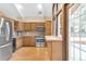 Kitchen featuring stainless steel appliances, wood cabinets, and a window overlooking the yard at 2978 Robb Cir, Lakewood, CO 80215