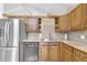 Bright kitchen with wood cabinets, modern appliances, and a large stainless steel refrigerator at 2978 Robb Cir, Lakewood, CO 80215