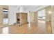 Open-concept living room featuring a stone fireplace, hardwood floors, and large windows at 2978 Robb Cir, Lakewood, CO 80215