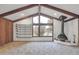 Open living room with wood beams and a unique fireplace feature at 2978 Robb Cir, Lakewood, CO 80215