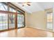 Bright living room with hardwood floors, a ceiling fan, and large windows at 2978 Robb Cir, Lakewood, CO 80215