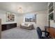 Spacious bedroom with built-in shelving and a sofa at 3855 S Monaco St # 176, Denver, CO 80237