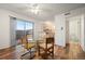 Open dining area with glass table and view to the kitchen and patio at 3855 S Monaco St # 176, Denver, CO 80237