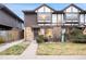 Exterior view of a two-story townhome with a small front yard and walkway at 3855 S Monaco St # 176, Denver, CO 80237